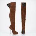A pair of brown faux-suede thigh-high boots with high stiletto heels, side zippers, and decorative black buckle straps near the top, shown against a plain white background with a faint store watermark.