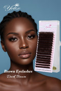A close-up of a woman with brown eyelashes next to a package of Yelix brand dark brown false eyelashes on a pink card.
